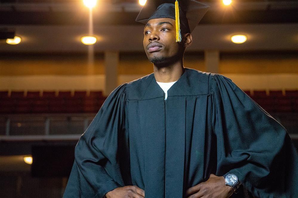  Student wearing graduation cap and gown
